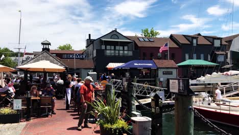 Panning-through-Newport-waterfront-pedestrian-zone-and-marina-with-boats