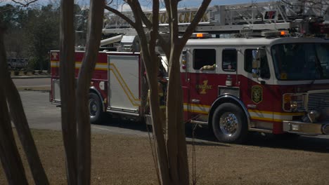 Firefighter-exits-a-fire-ladder-truck-to-begin-getting-fire-fighting-equipment-ready-for-to-fight-a-fire