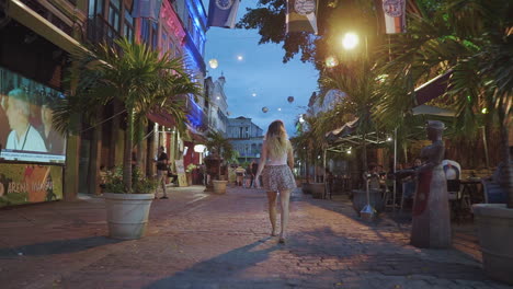 Shot-of-model-walking-through-the-streets-of-Rio-De-Janeiro---Brazil-at-dusk,-November-2018