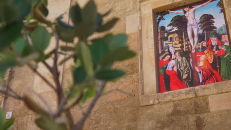 Reveal-of-Crucifiction-Stained-Glass-Window-Through-Tree-Branch-at-the-Cathedral-of-Santa-Maria-of-Palma