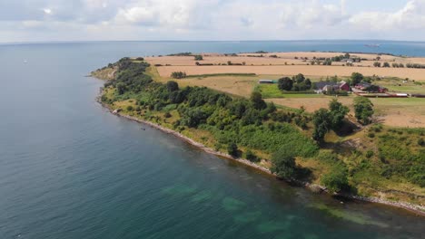 Aerial-view-paning-the-south-part-of-the-island-of-Ven-in-southern-Sweden-outside-the-village-and-harbor-of-Bäckviken