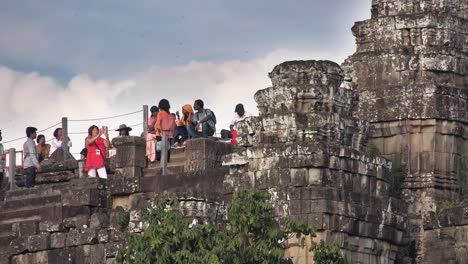 Tourists-Sitting-and-Taking-Pictures-at-Bakheng-Temple