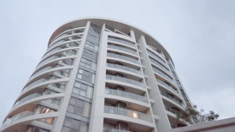 Stabilized-Video-taken-from-Motorcycle-in-late-evening-looking-up-at-trees-and-street-lights-and-circling-modern-buildings-in-a-new-and-affluent-district-of-the-City