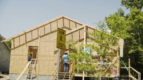 Drive-By-Wide-Shot-of-Home-Construction-in-Development-on-Sunny-Day