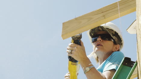 Female-Worker-Cuts-Wood-with-Reciprocating-Saw,-Slow-Motion,-Close-Up