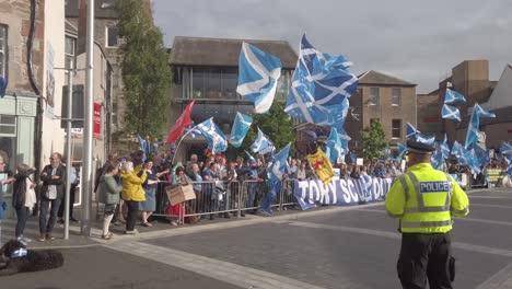 A-police-officer-watches-Scottish-protesters-outside-the-Perth-Concert-Hall-where-the-Tory-Leadership-Hustings-is-being-held