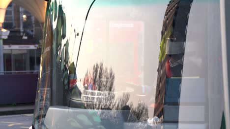 LONDON,-UK---April-10th-2020:-Red-bus-driver-with-mask-and-safety-glove-driving-at-the-station-for-the-tfl-of-london-transportation-for-commuters