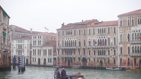 Tilt-Down-Shot-of-Sailing-Boat-on-the-Grand-Canal-in-Venice-italy