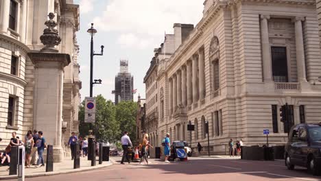 Sunny-day-in-London-Great-George-street-full-of-walking-people-and-cars,-Big-Ben-in-background