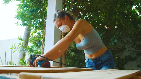 A-Young-Woman-Busy-Working-With-Wooden-Pallets-At-The-Shop-During-The-Day---Close-Up-Shot