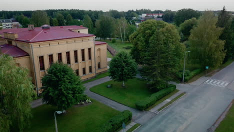 Aerial-view-dolly-in-of-Smiltenes-High-School-in-low-altitude,-Latvia