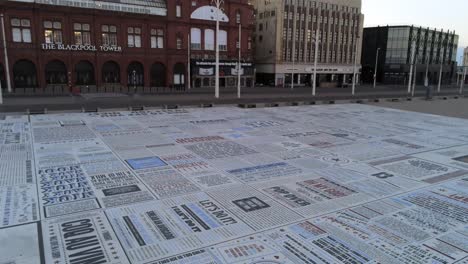 Blackpool-tower-promenade-comedy-carpet-aerial-view-seaside-attraction-tilt-down-pan-right