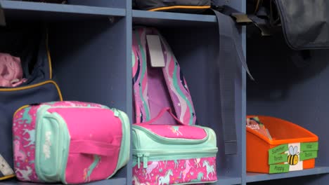 Colorful-School-Bags-In-Classroom-Lockers-Organized,-TILT-UP