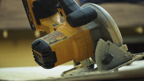 Dusting-a-electric-dewalt-sander-on-a-wooden-ramp-closeup