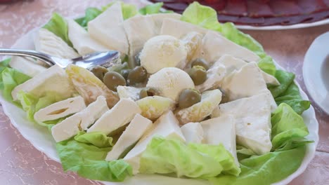 Plate-with-cheese,-olives,-cream,-kaymak,-peppers-and-lettuce