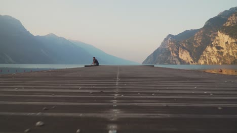 Pier-in-Riva-del-Garda's-beach-with-Garda-lake-at-sunrise