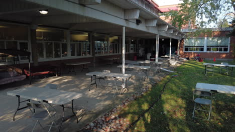 Wide-exterior-time-lapse-of-empty-lunch-tables-being-cleaned-up-after-lunch-on-a-film-production