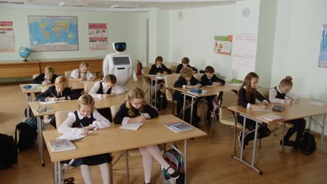 Robot-teacher-futuristic-school-wide-shot-of-a-classroom-full-of-students-doing-their-homework-or-assignment