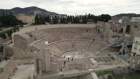 People-visiting-the-Ruins-of-The-Roman-Theatre-of-Cartagena,-ancient-city-landmark,-Spain