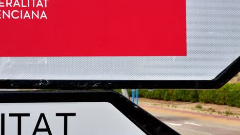 Slow-pan-between-two-signs-pointing-to-a-vaccination-center-in-Alicante,-Spain