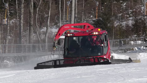 Red-snow-groomer-driving-on-a-snowy-ski-slope,Morava,Czechia