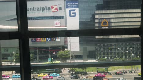 View-of-going-down-the-glass-elevator-looking-outside-Central-Plaza-Grand-Rama-9-in-Bangkok,-Thailand