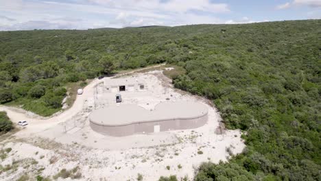 Dual-water-reservoir-tanks-with-chemical-cleanup-van-parked,-Aerial-orbit-around-shot