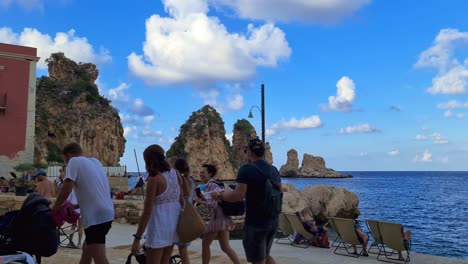 Tourists-at-Stacks-or-Faraglioni-of-Scopello,-Sicily-in-Italy