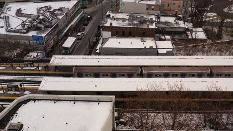 A-profile-view-a-subway-train-leaving-the-station-on-a-snowy-day