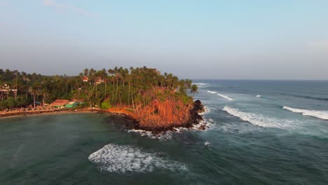 Toma-Aérea-De-Personas-Paradas-Cerca-De-Las-Rocas-Y-La-Isla-De-Las-Palmeras