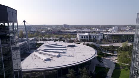 backwards-track-through-the-3-Turmfahrt-towers-in-Autostadt-in-Woflsburg,-Volkswagen