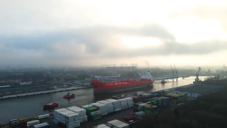 Tugboats-Pulling-Oil-Tanker-At-Martwa-Wisla-River-In-Nowy-Port-At-Sunrise-In-Westerplatte,-Gdansk,-Poland