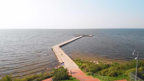 Aerila-view,-the-child-rides-with-a-scooter-on-the-pier-ant-Vente-cape