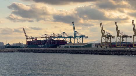 Port-of-Barcelona-at-sunset-Kay-line-Towers-and-cranes-loading-container-ships-passenger-ferry