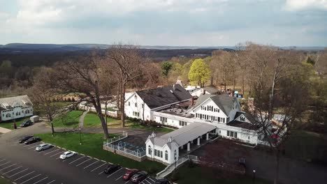 Ascending-and-fly-away-view-of-majestic-white-mansion-for-celebration