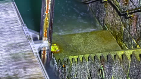 Timelapse-of-outgoing-water-during-ebb-tide-or-low-tide-at-shore-with-moving-wooden-jetty