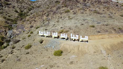 Aerial-view-around-the-Al-bahah-sign,-in-sunny-Saudi-Arabia---orbit,-drone-shot