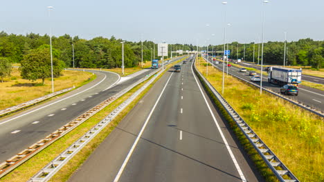 Time-lapse-of-oncoming-traffic-driving-on-highway-in-summer---Slow-zoom-out