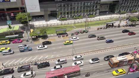 High-angle-view-of-Traffic-around-Ratchadaphisek-Road,-Rama-9-Intersection,-near-department-stores-during-the-Covid-19-situation-in-Bangkok,-Thailand