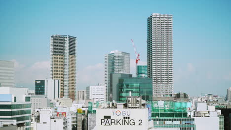 Modern-buildings-and-construction-work-in-Ikebukuro,-within-the-Toshima-city-area-of-Tokyo,-Japan