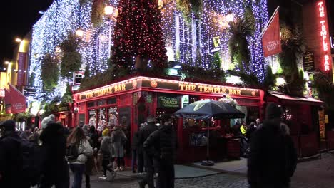 Dublin-The-Temple-Bar-at-night-with-people-passing-by