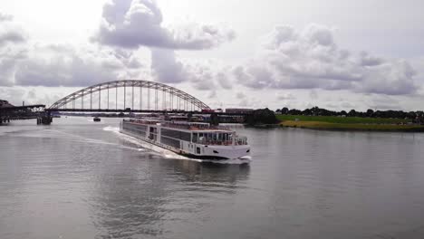 Viking-Ve-Cruise-Longship-Navegando-A-Lo-Largo-Del-Río-Noord-Con-Brug-Over-De-Noord-En-El-Fondo