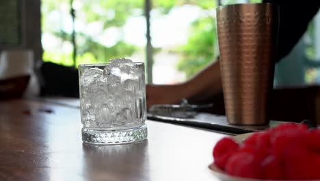 Latin-Restaurant-Bartender-slide-glass-with-ice-in-slow-motion-and-picking-up