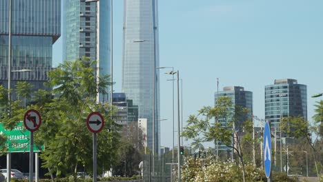 Tilt-up-of-people-walking-in-modern-Sanhattan-area-with-tall-skyscrapers-in-background-at-daytime,-Santiago,-Chile