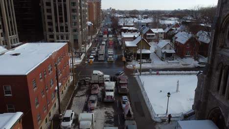 aerial-drone-shot-of-trucks-and-protesters-block-the-intersection-of-Streets-during-the-Anti-vaccine-convoy-protests-titled-"Freedom-convoy"-in-Ottawa,-Ontario,-Canada-on-January-30st-2022