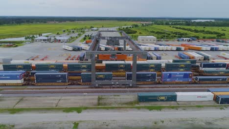 4K-Drone-Video-of-Trains-and-Trucks-at-CSX-Intermodal-Train-Yard-in-Winter-Haven,-FL