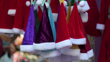 Red,-purple,-and-turquoise-Christmas-hats-for-sale-are-seen-at-a-street-stall-in-Hong-Kong