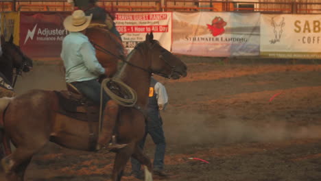 Slow-motion-shot-of-cowboy-sitting-over-the-horse-while-jumping-and-kicking