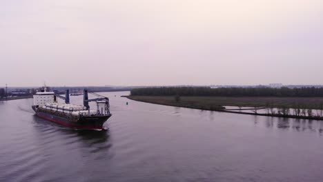 Aerial-View-of-Fortune-Cargo-Ship-Approaching-Along-Oude-Maas-On-Cloudy-Day