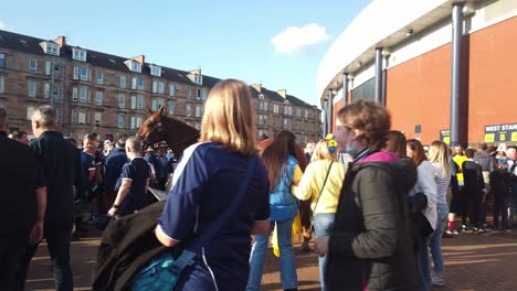 A-female-mounted-police-officer-is-surrounded-by-football-fans